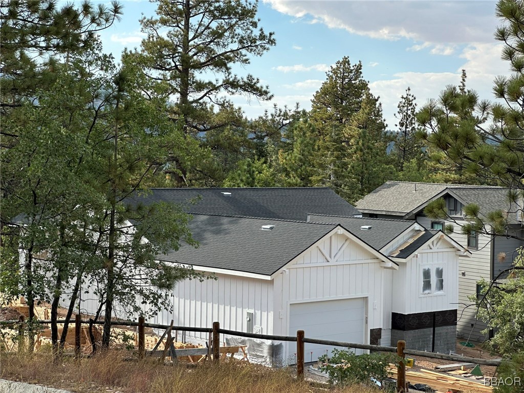 a view of house with outdoor space and sitting area