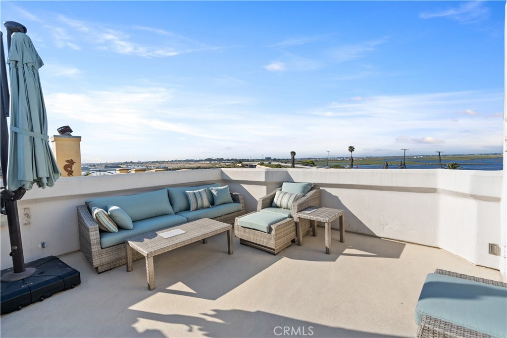 a view of a terrace with couches and sky view