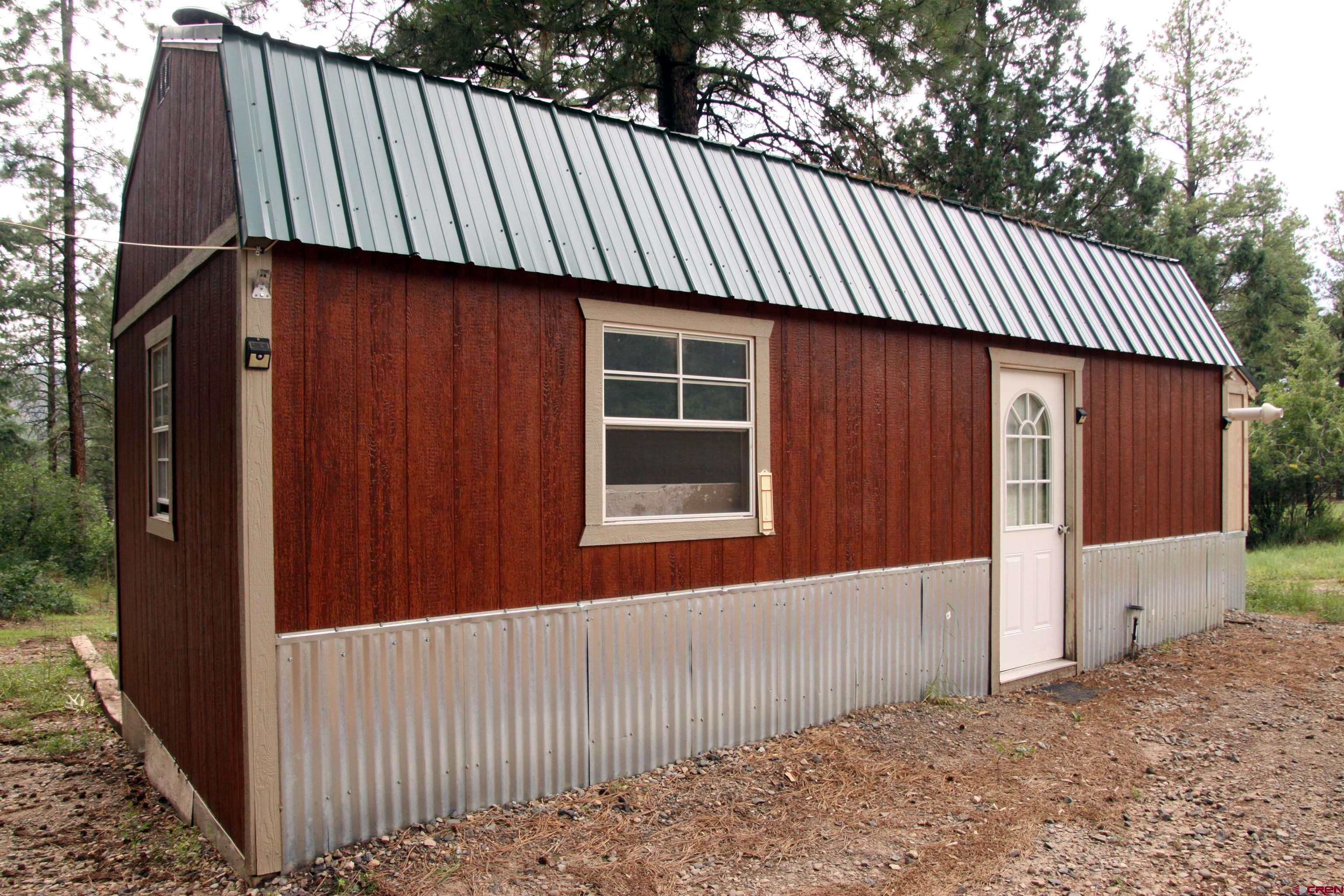 a view of a house with backyard and deck