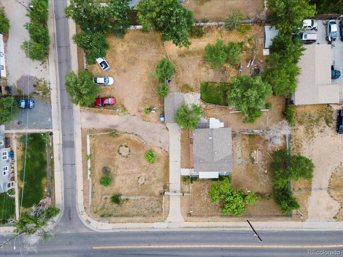 an aerial view of a house with garden space and street view