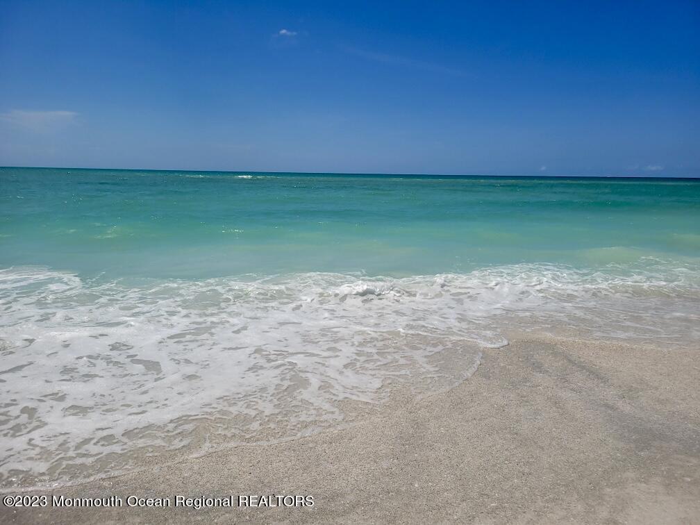 a view of a field with an ocean