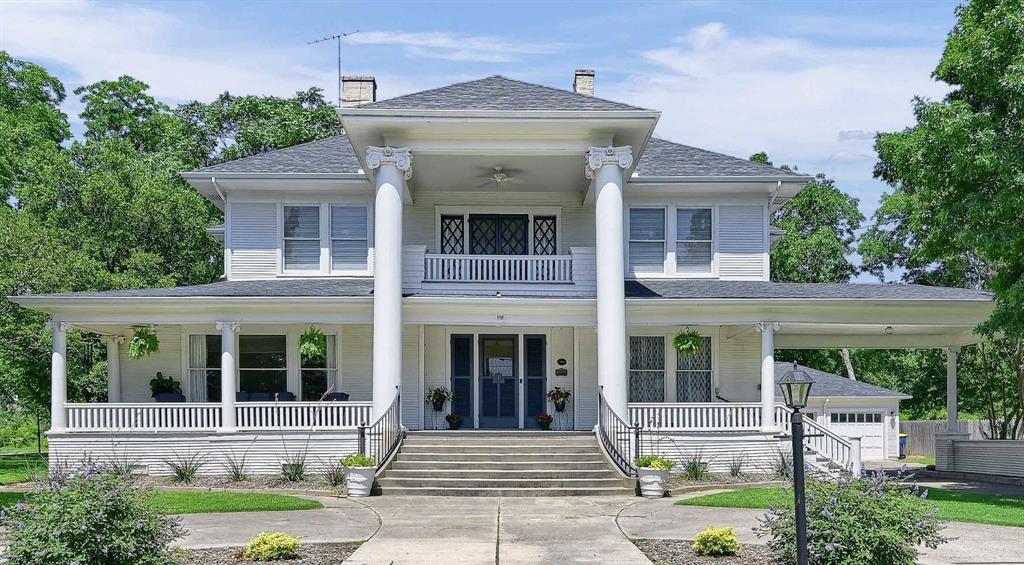 a front view of a house with garden and porch