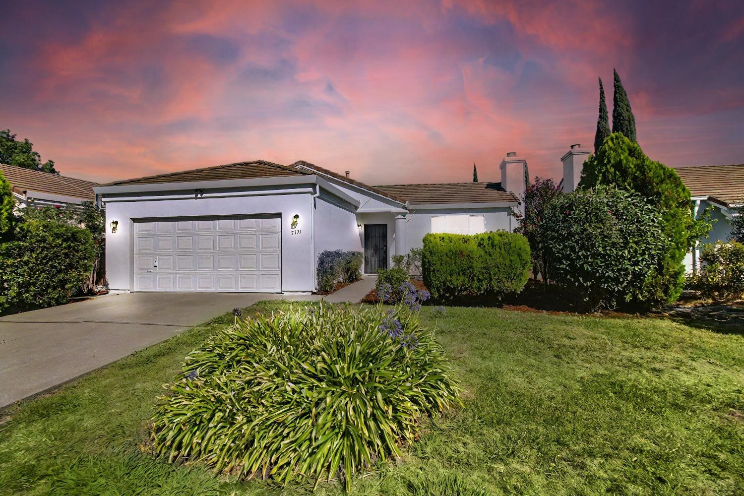 a front view of a house with garden