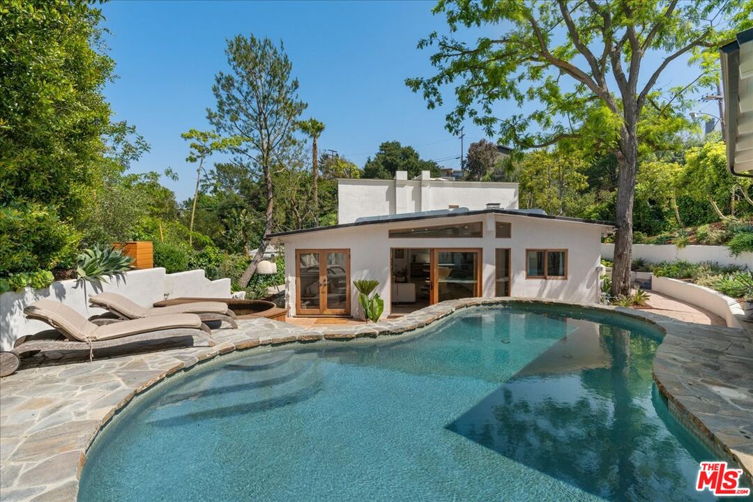 a view of a house with backyard and sitting area