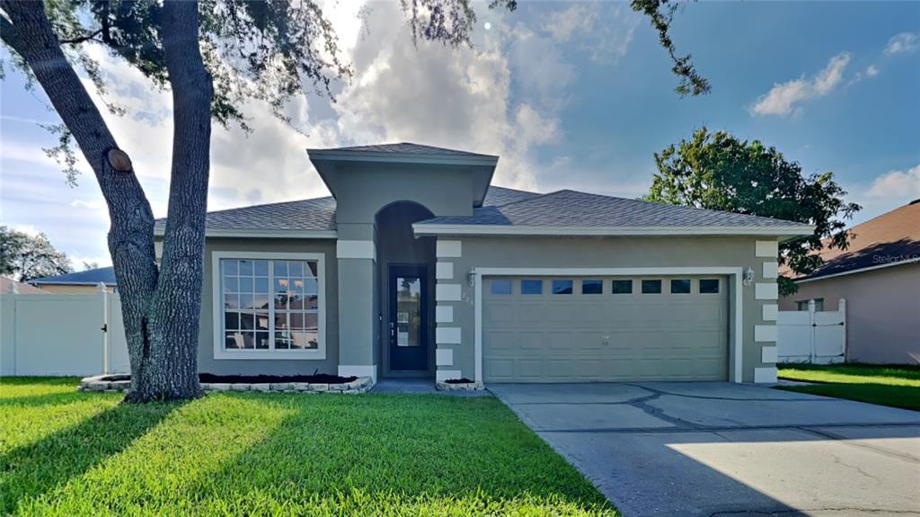 a front view of a house with a yard and garage