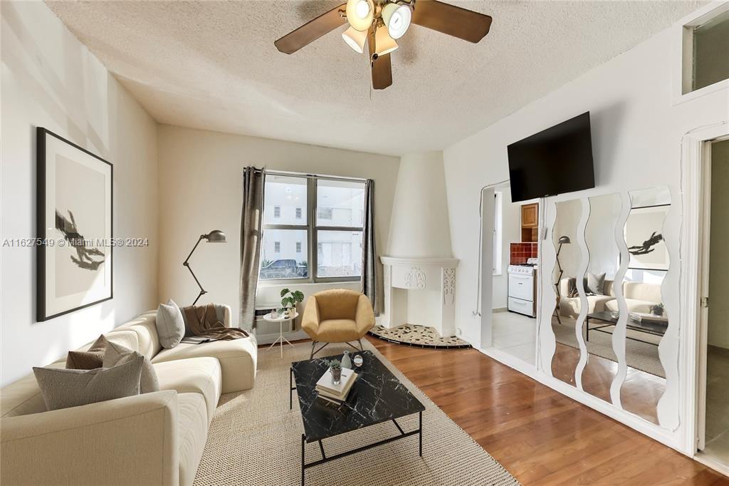 a living room with furniture tv and a fireplace