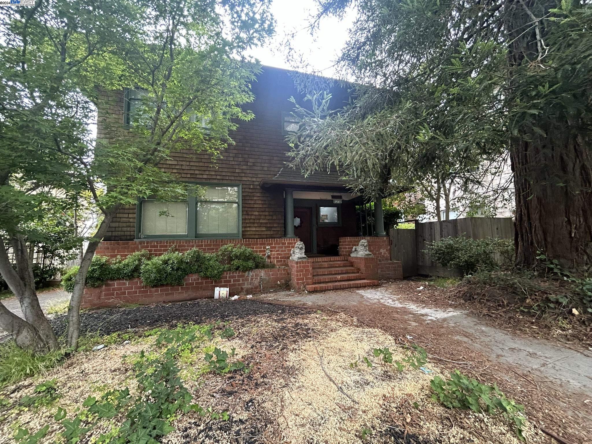 front view of a house with a yard and an trees