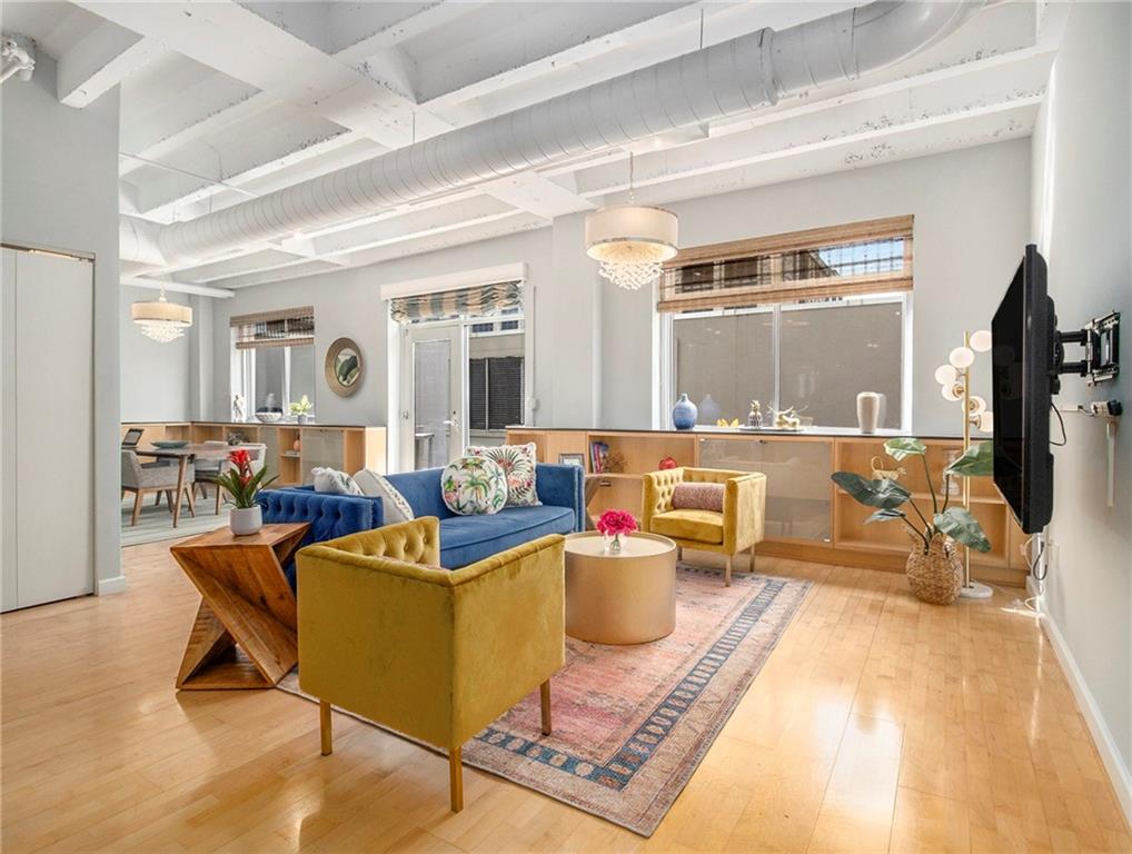 a living room with furniture and a potted plant