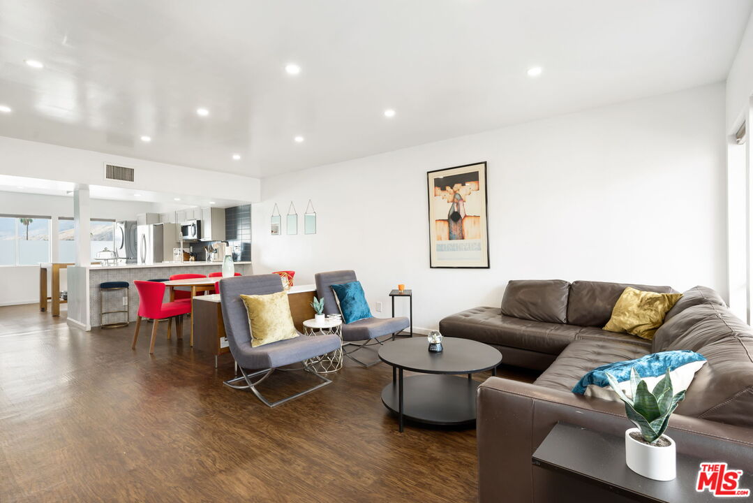 a living room with furniture and kitchen view