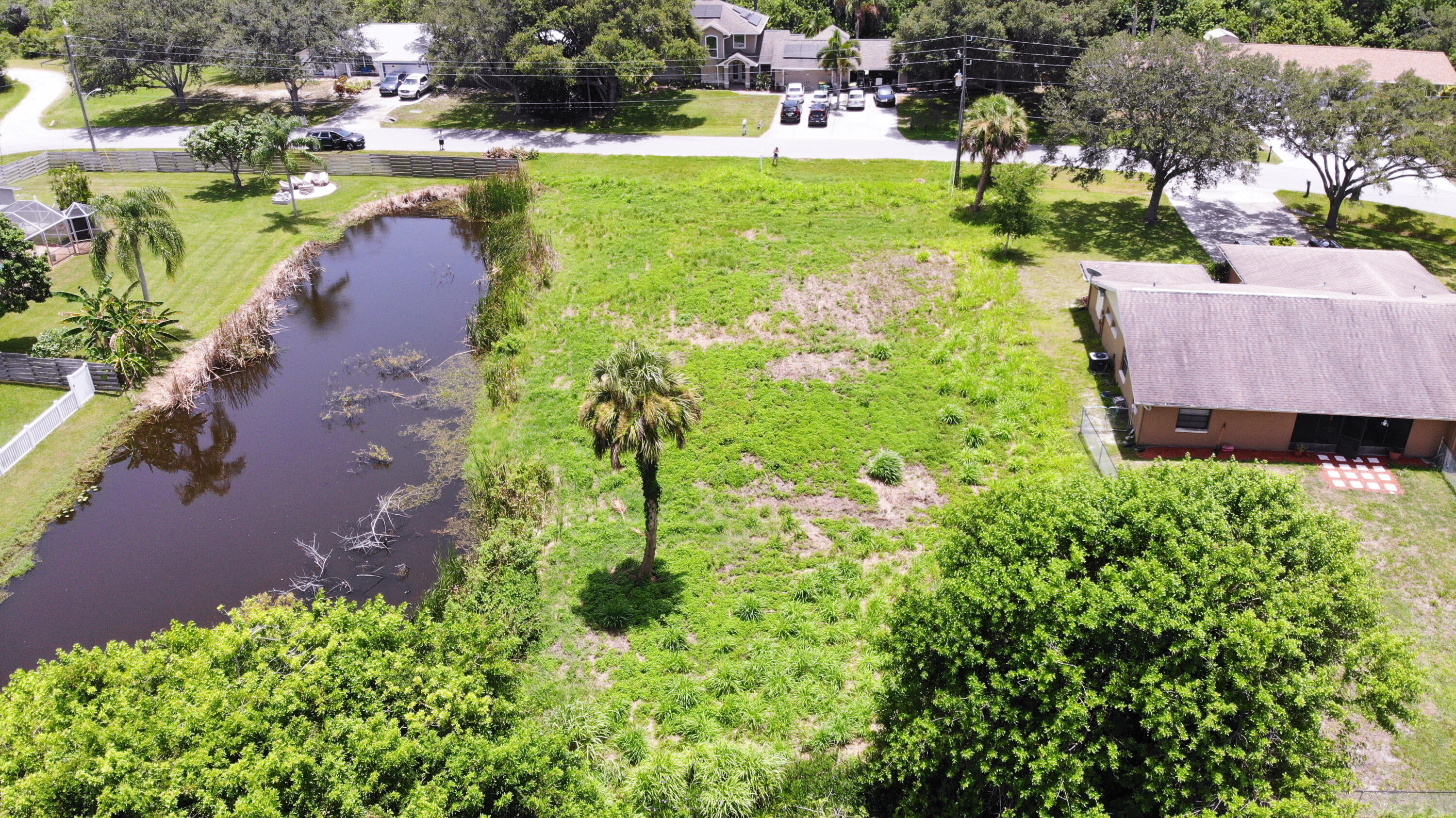 an aerial view of a house with a yard basket ball court and outdoor seating