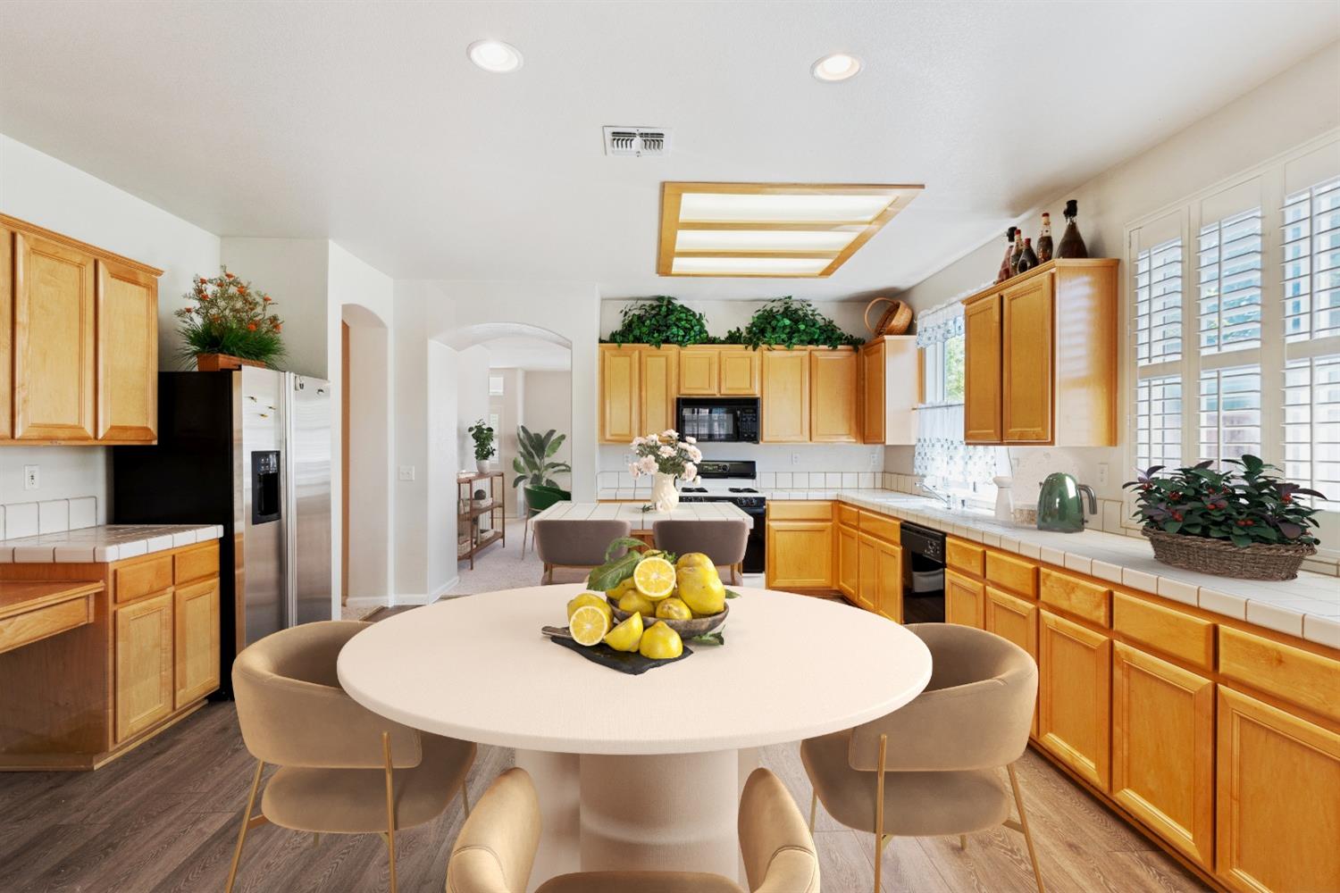 a kitchen with stainless steel appliances a dining table and chairs