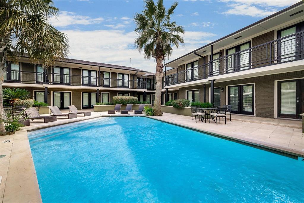 a swimming pool view with a garden and plants