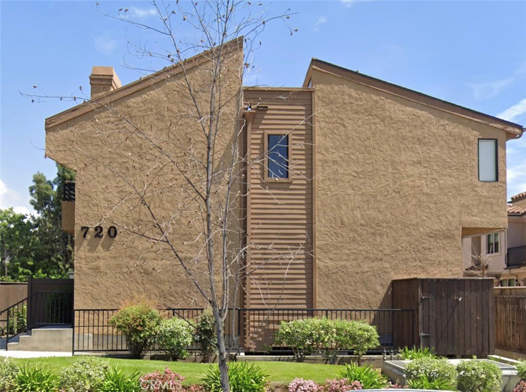 a view of a brick building next to a yard