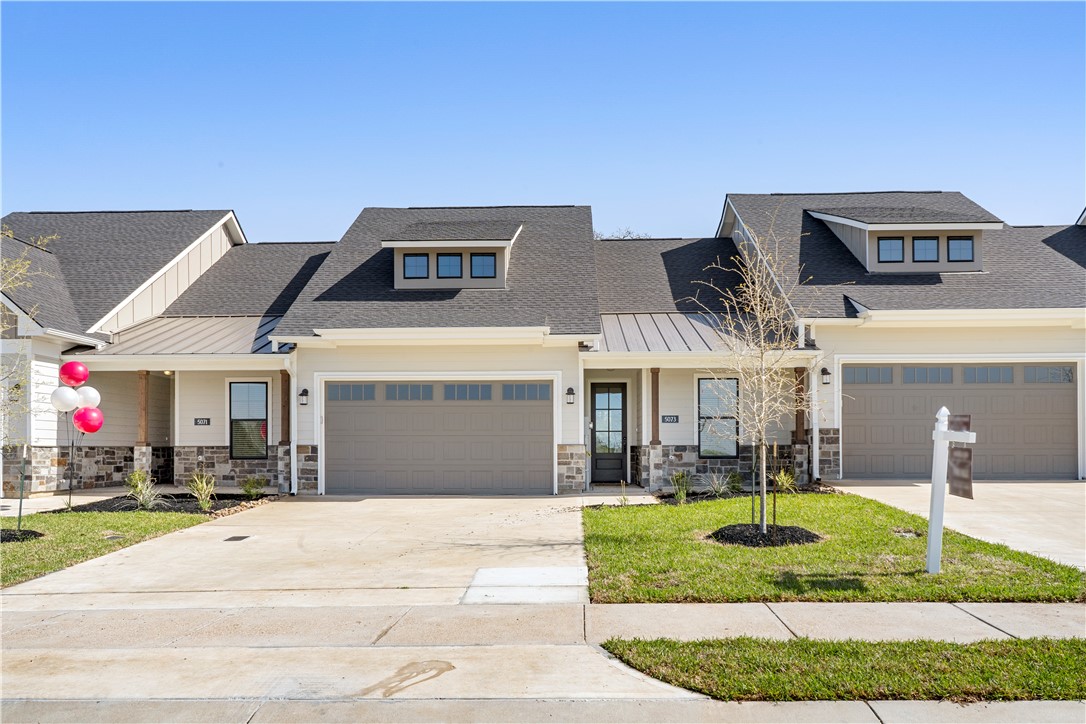 View of front facade with a garage and a front yar