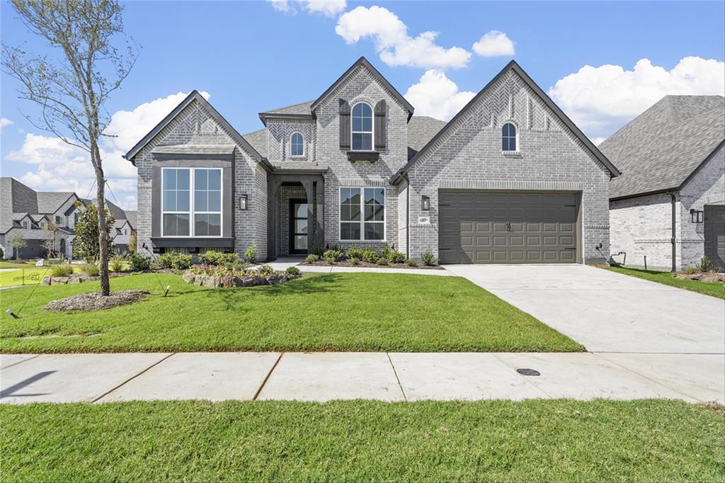 a front view of a house with a yard and garage