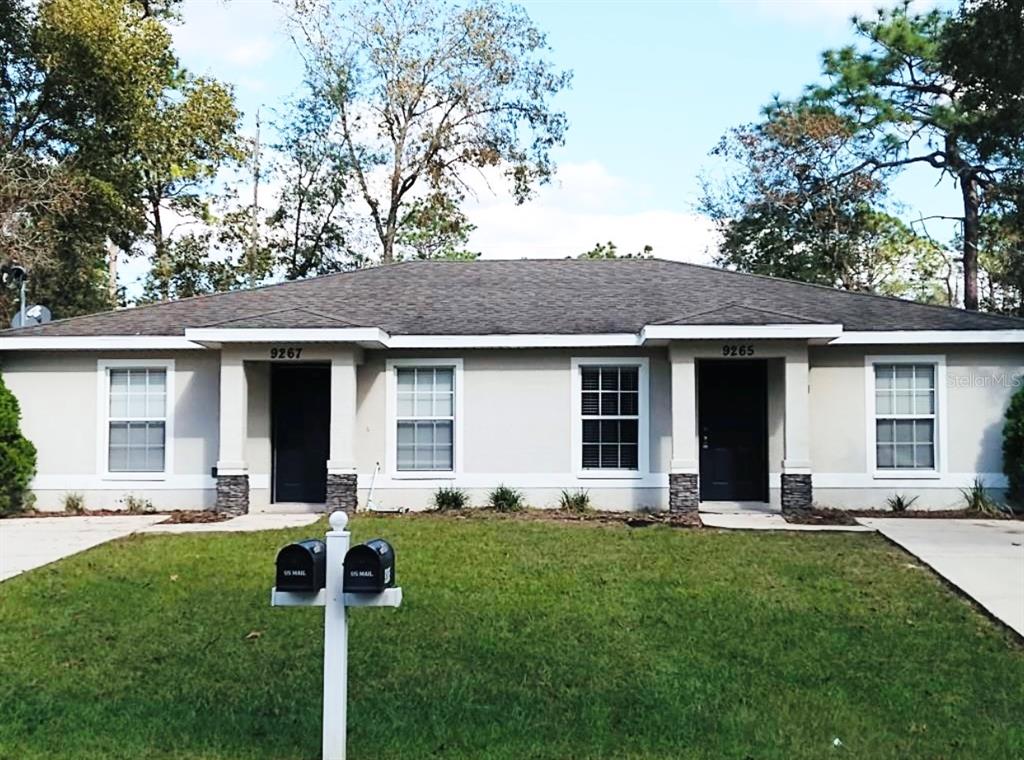 a front view of house with yard and green space