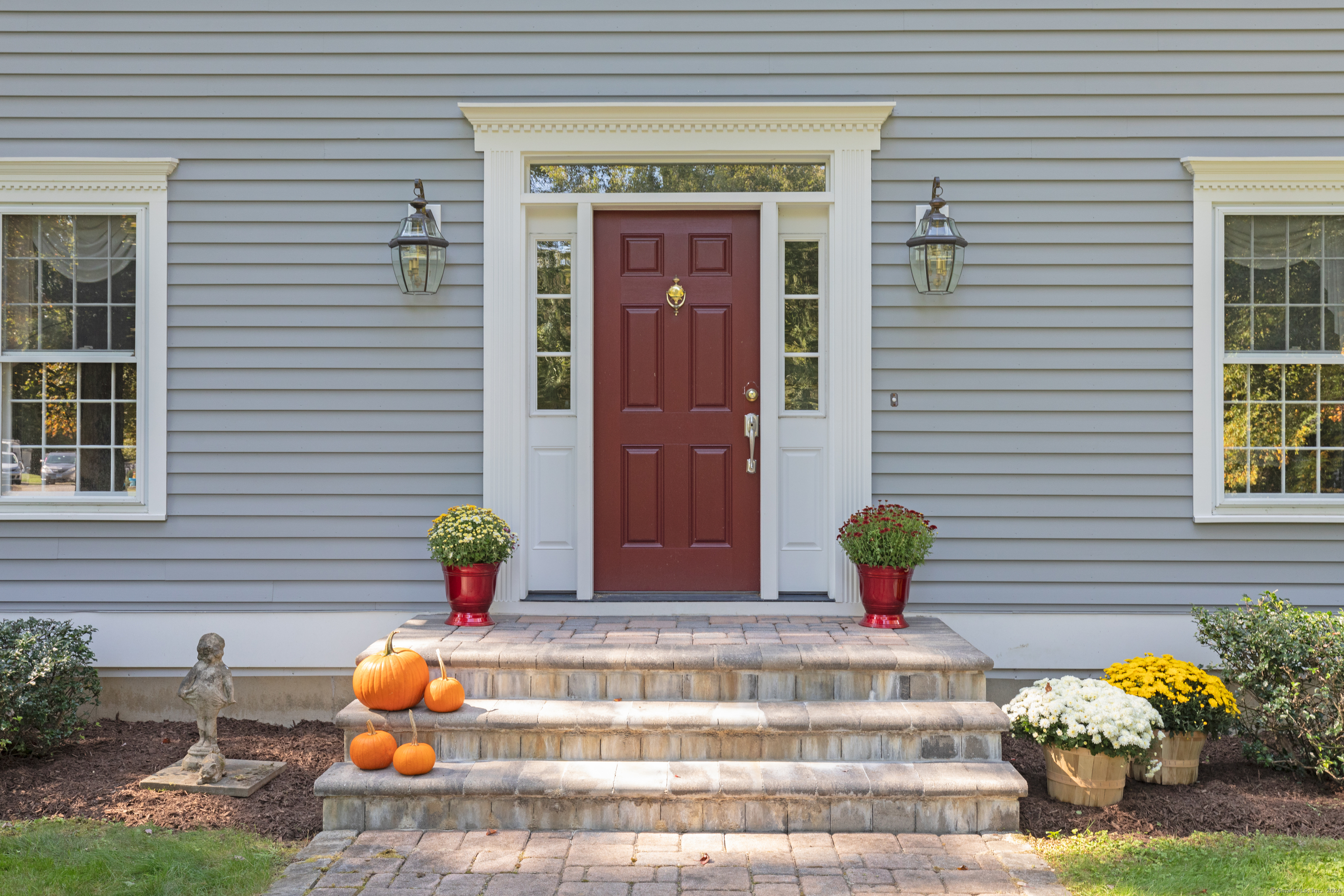 a front view of a house with outdoor seating and flowers