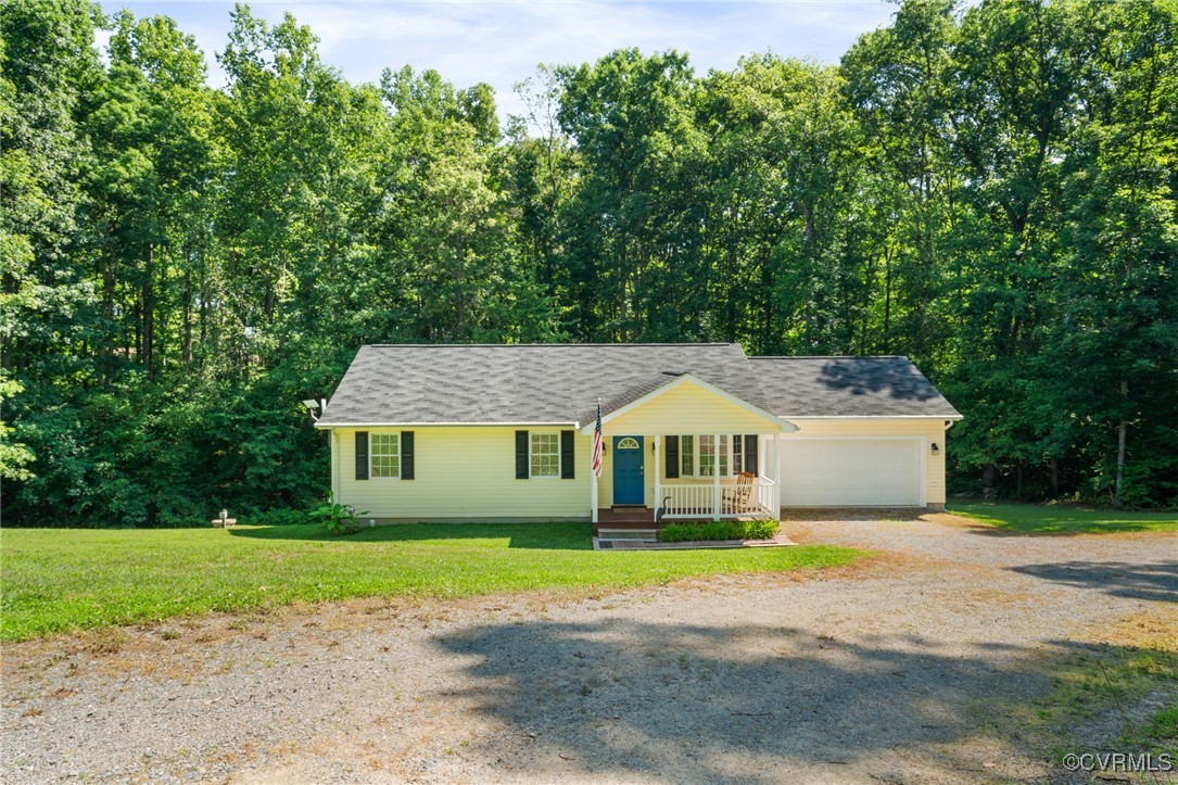 Ranch-style home featuring a front yard, covered p