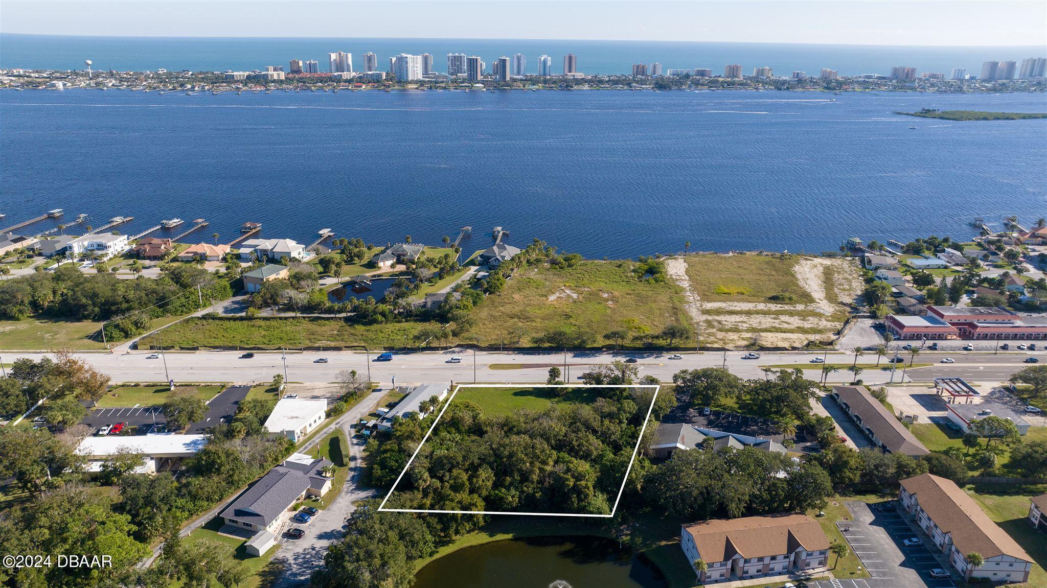 an aerial view of a house with a lake view