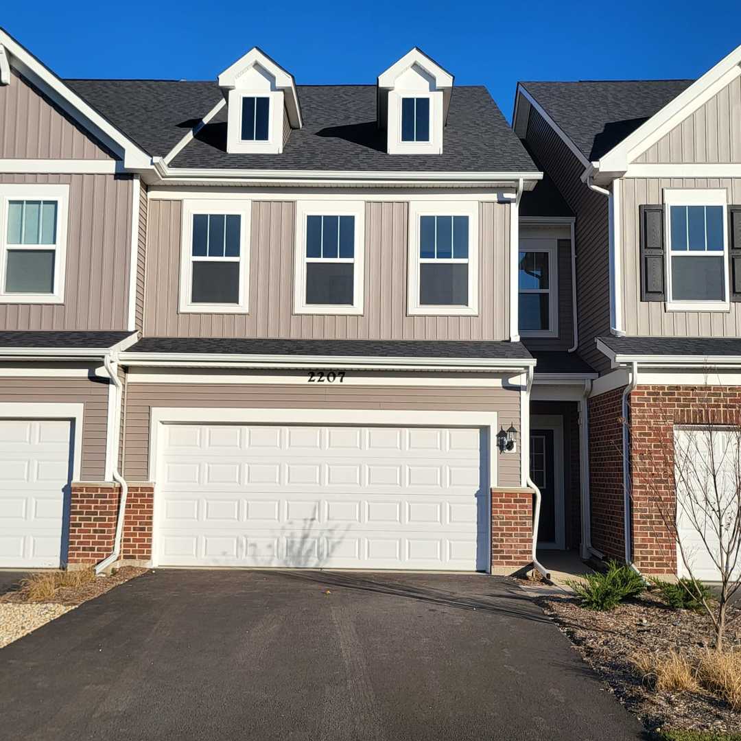 a front view of a house with lots of windows