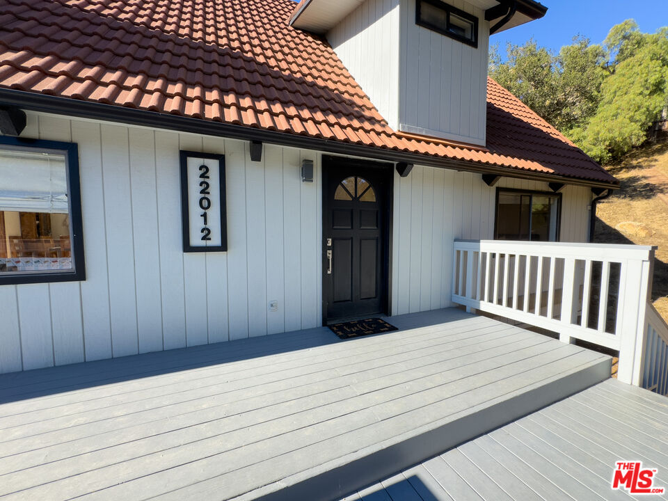 a view of a house with a wooden deck