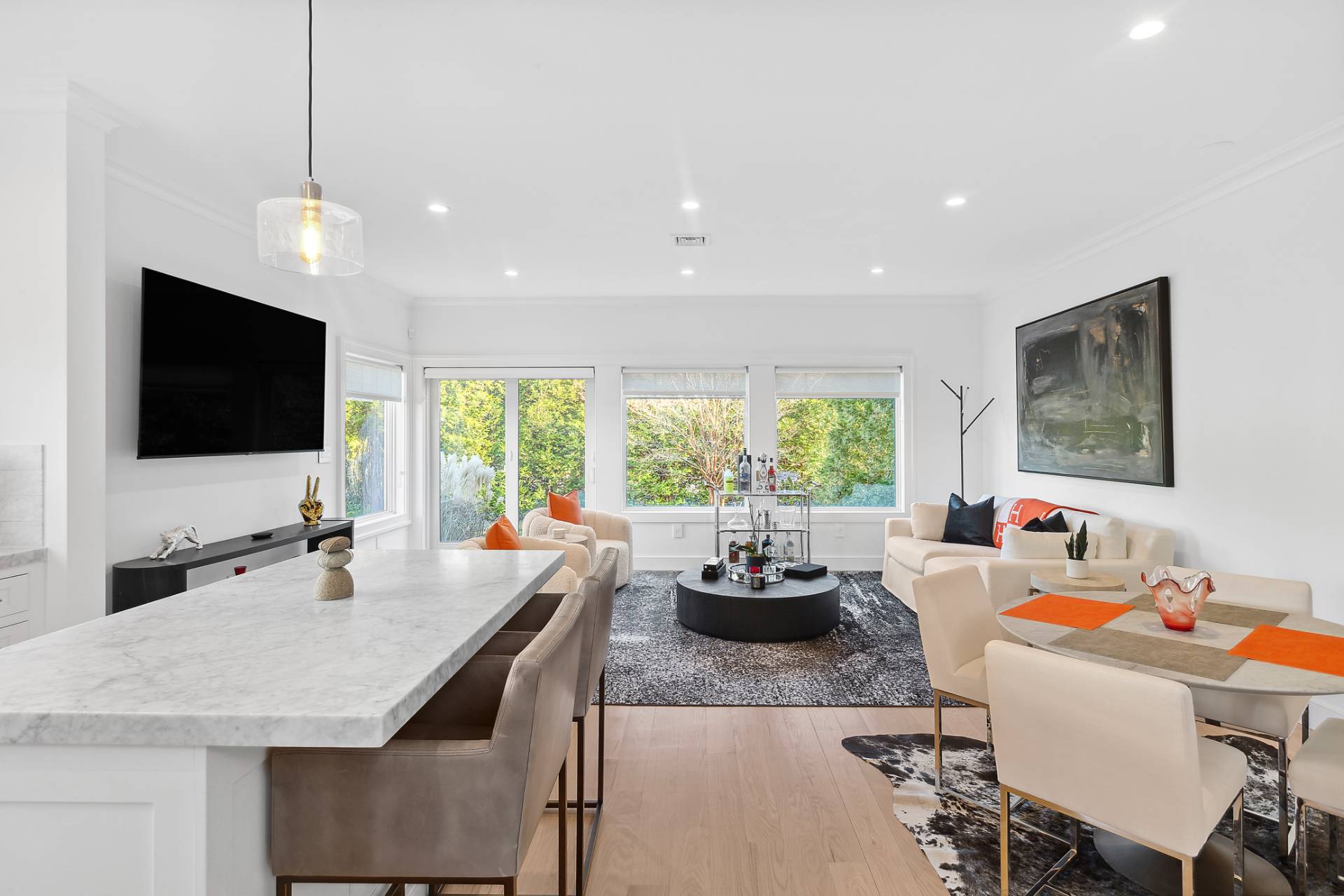 a kitchen with a stove a sink a dining table and chairs