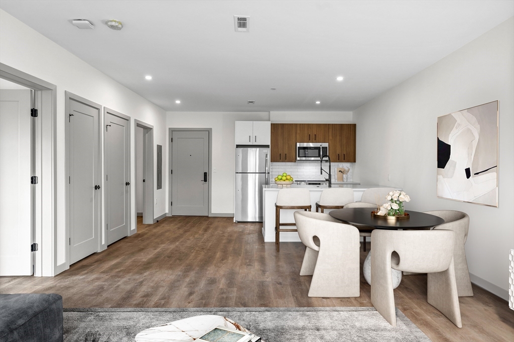 a kitchen with a refrigerator and a sink