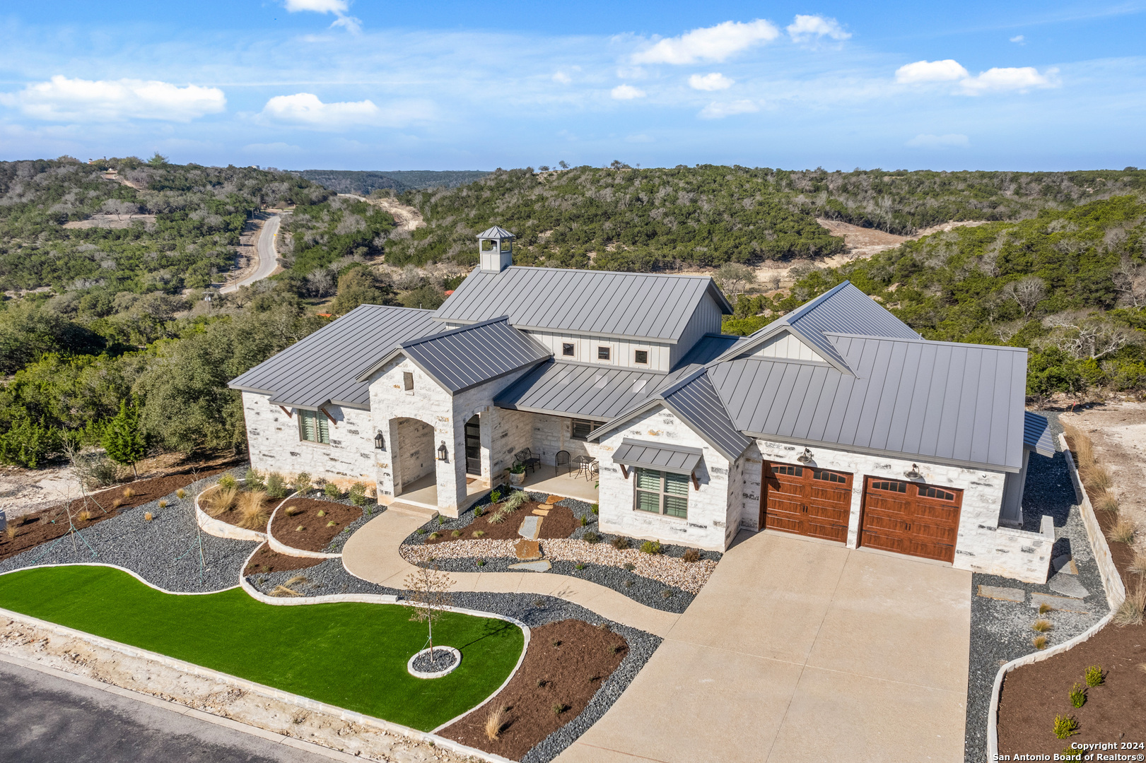 an aerial view of a house with swimming pool and mountain view