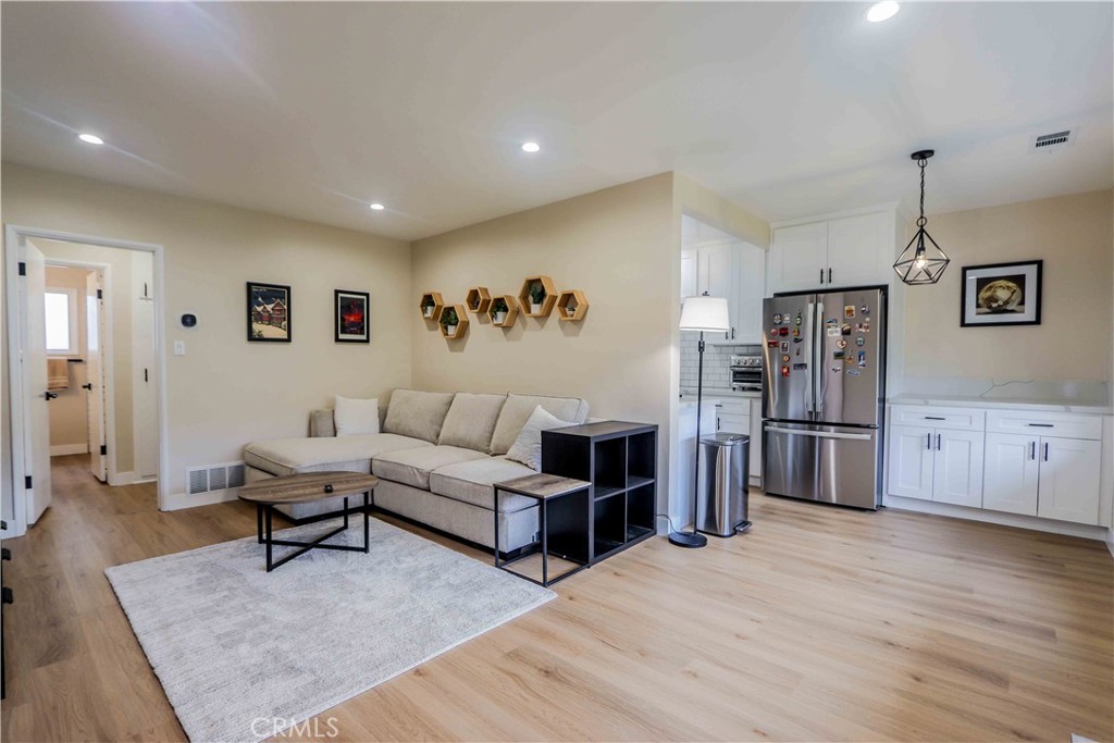 a living room with furniture and a kitchen view