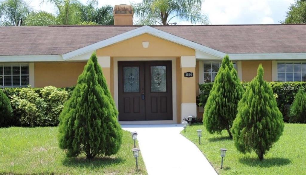 a front view of a house with a garden