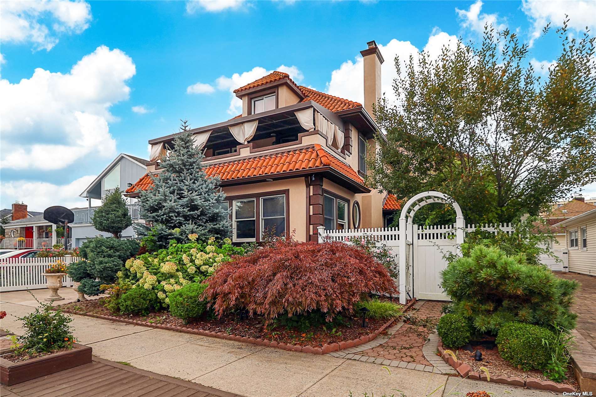 a front view of a house with a yard and outdoor seating