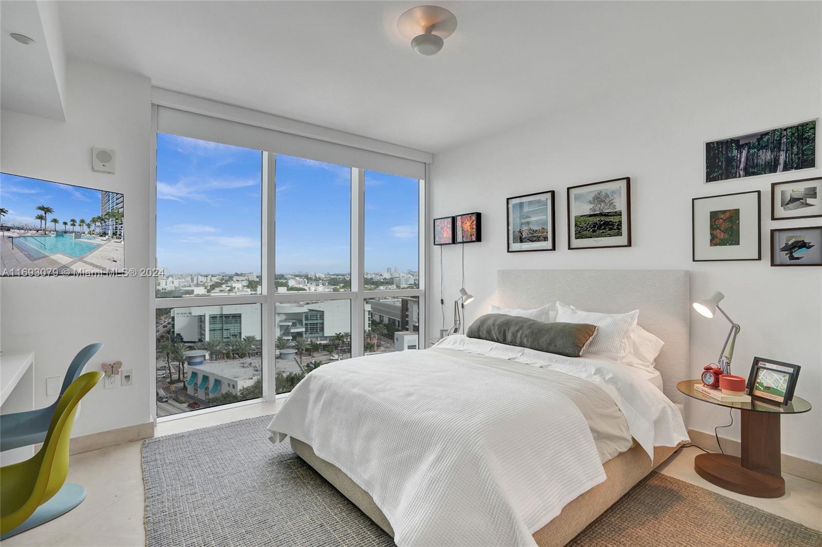 a bedroom with a bed and a large window