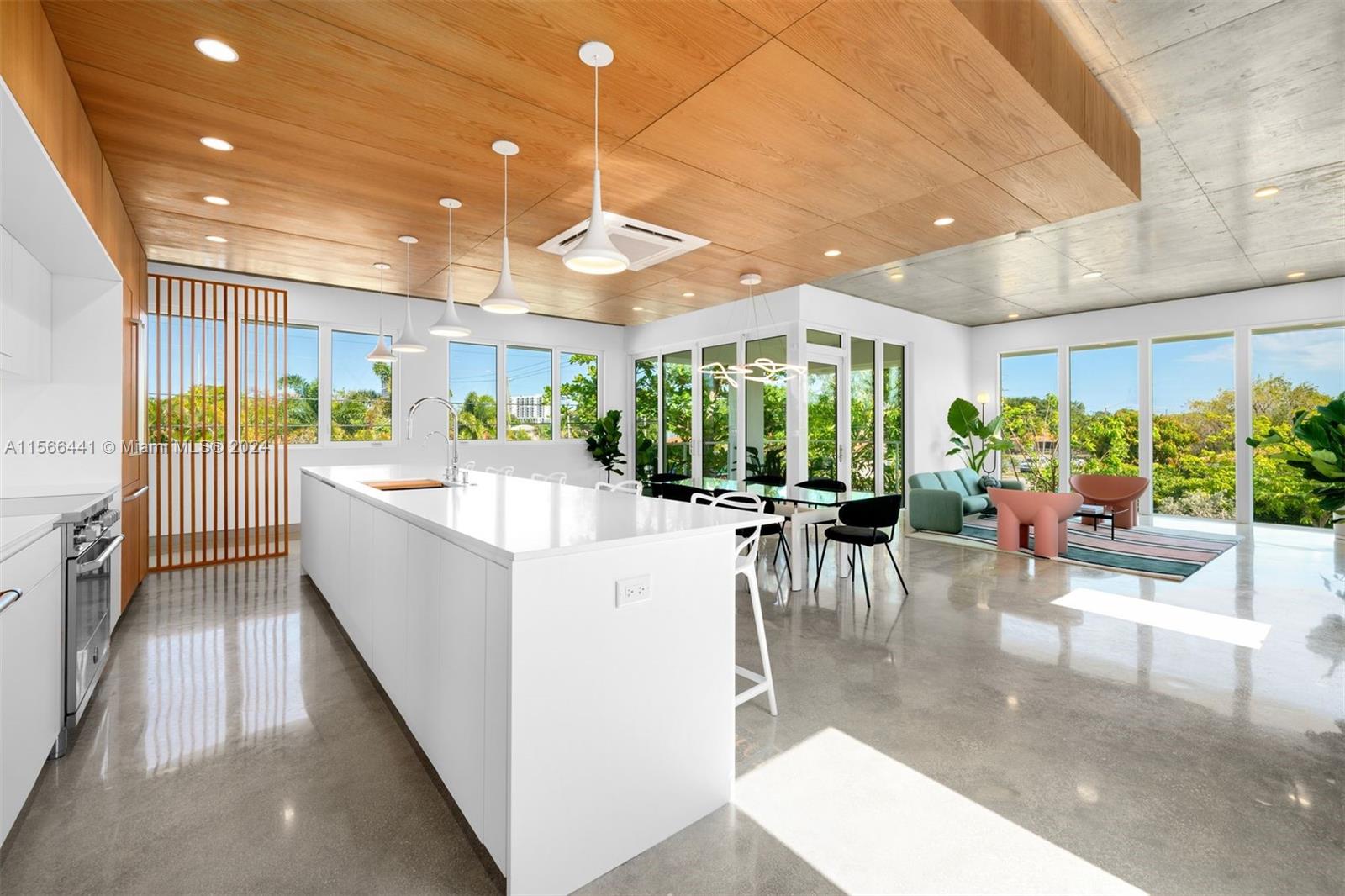 a large white kitchen with a large window