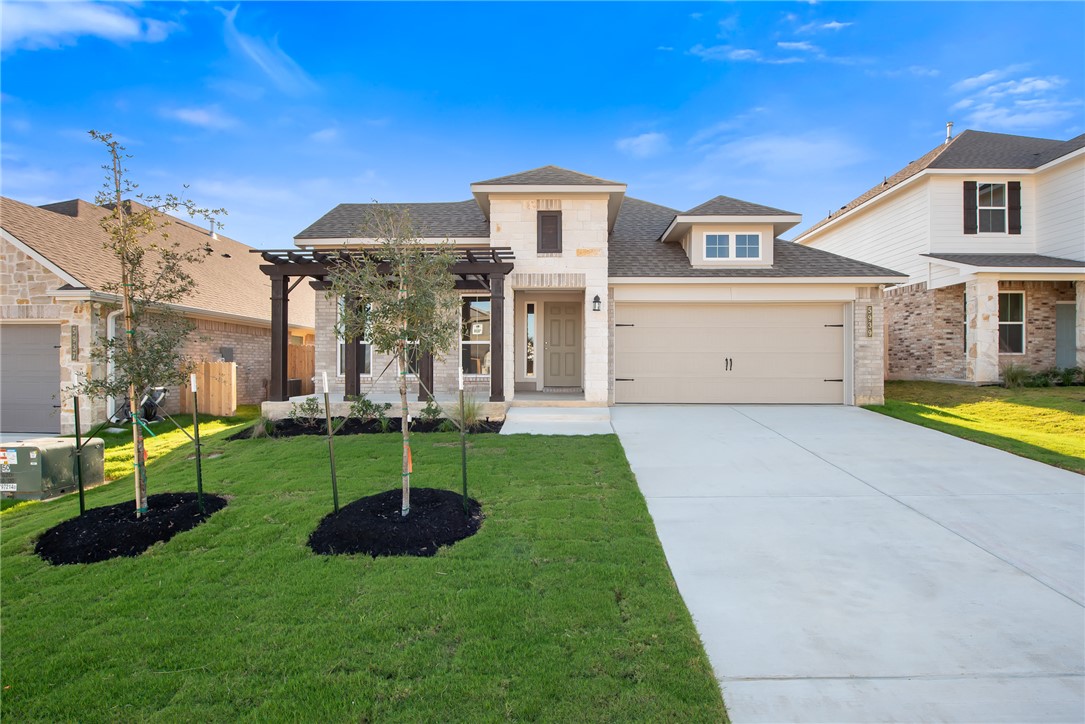 View of front of house featuring a garage and a fr