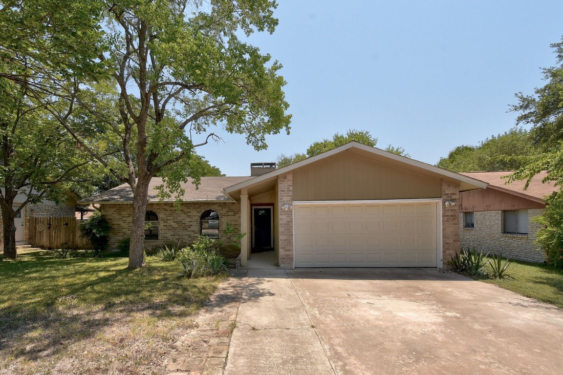 a view of garage and wooden fence