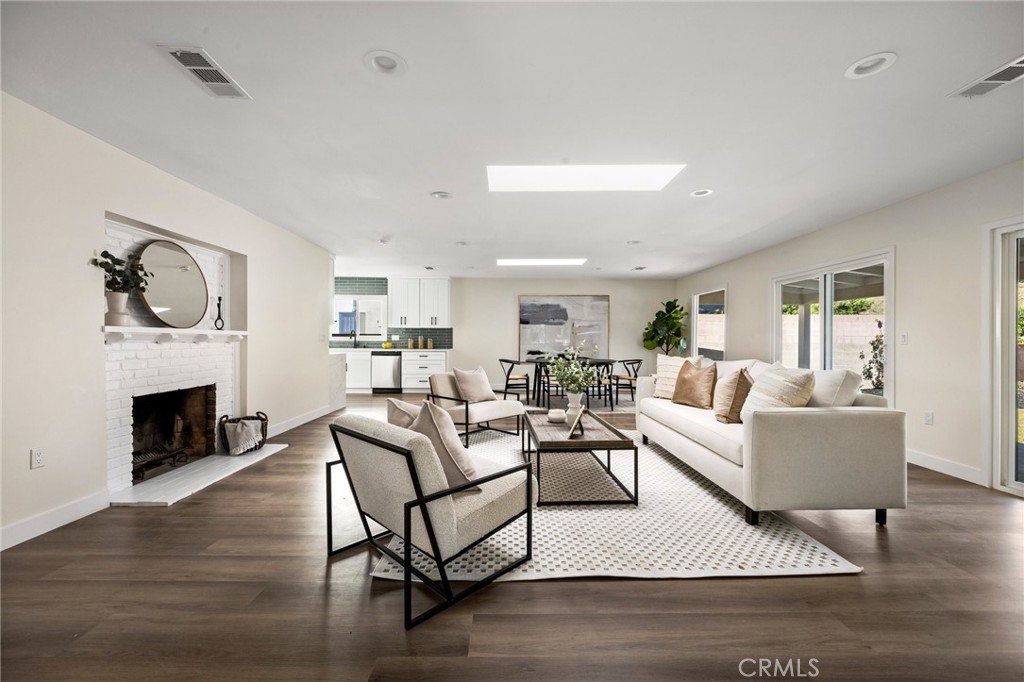 a living room with furniture a fireplace and a table