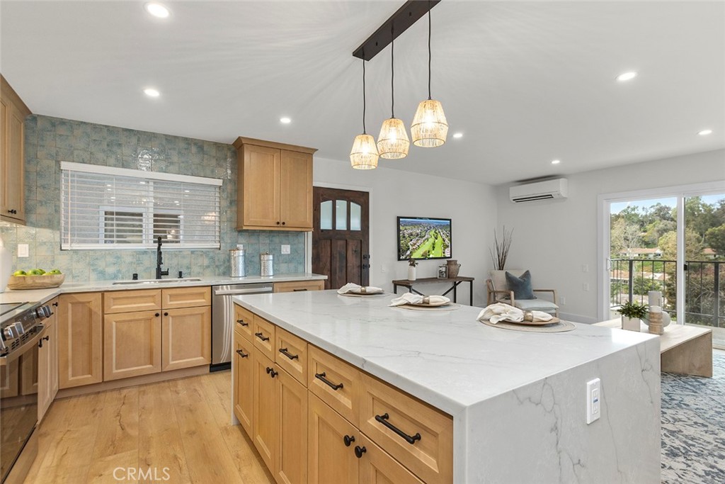 a kitchen with a sink a counter top space and appliances