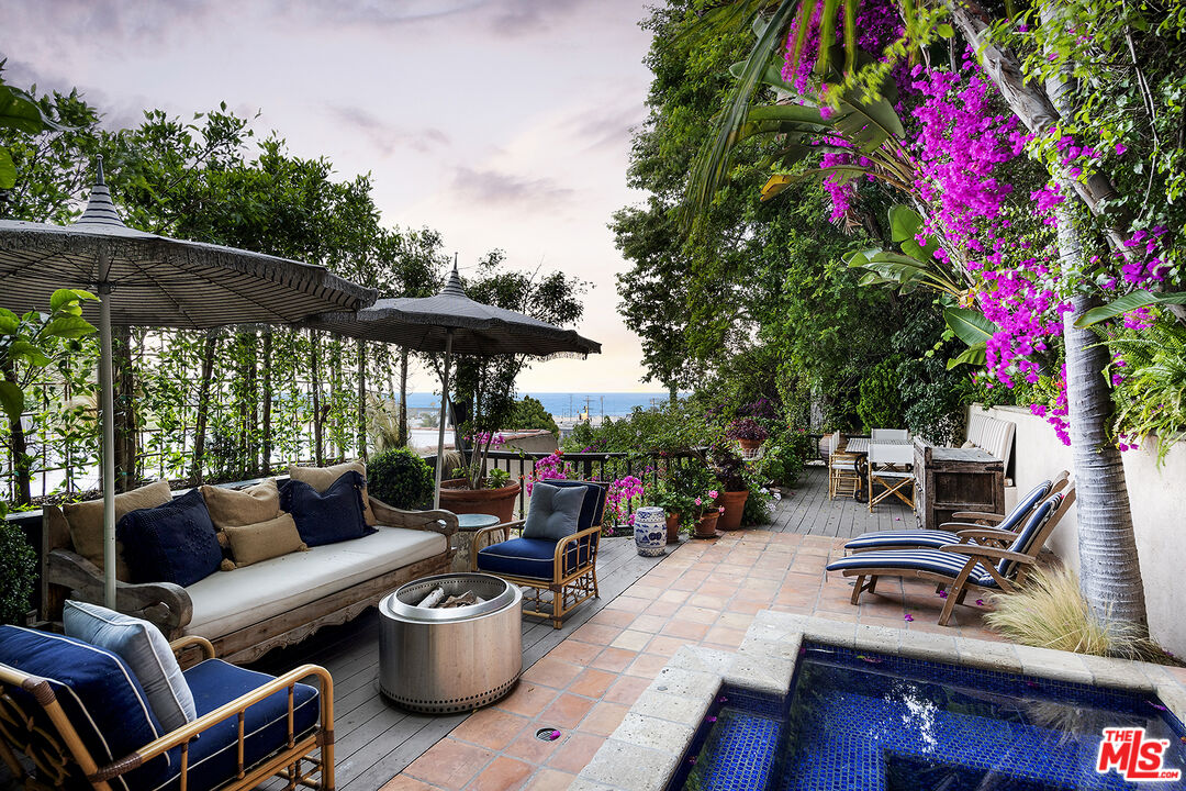 a backyard of a house with barbeque oven table and chairs