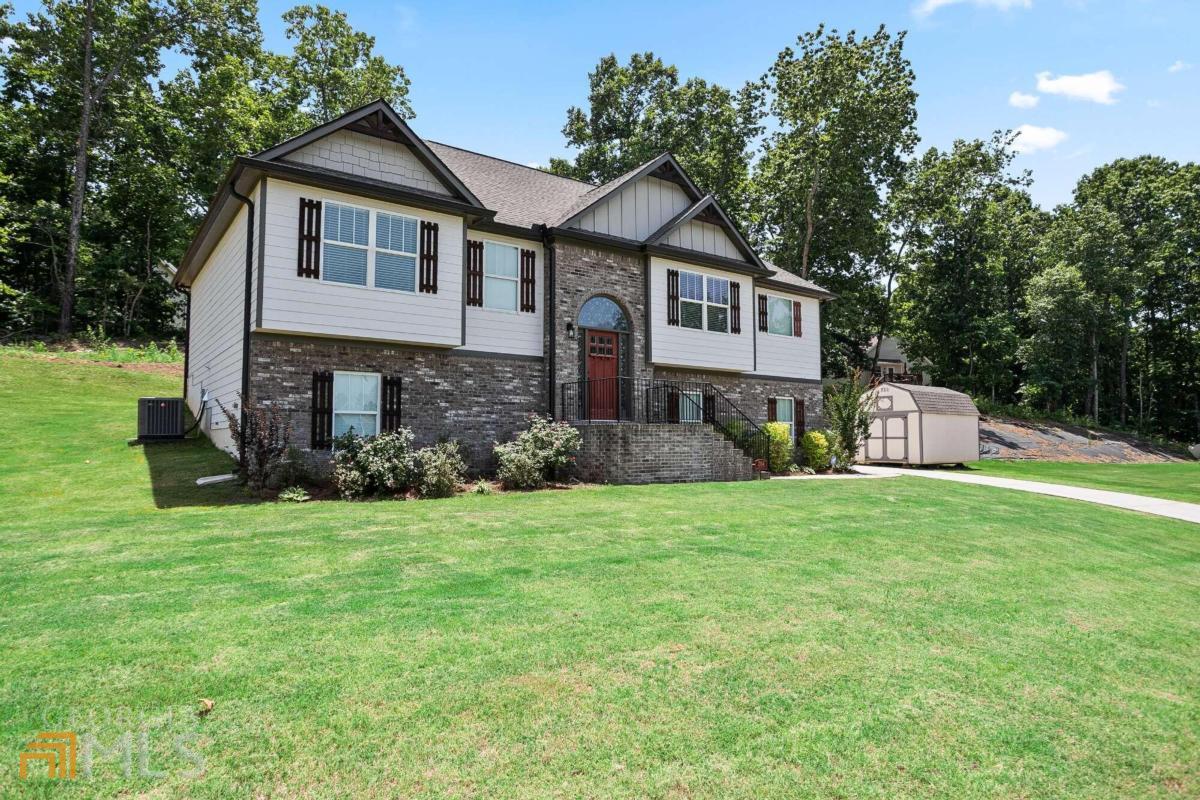 a front view of a house with a yard and garage