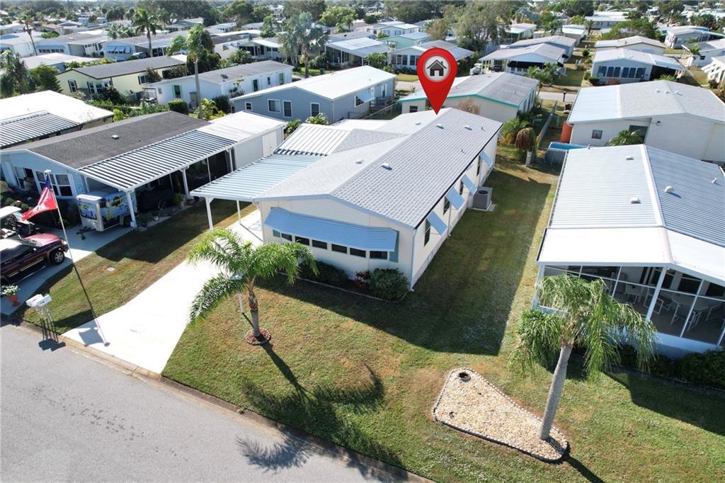 an aerial view of a house with a yard