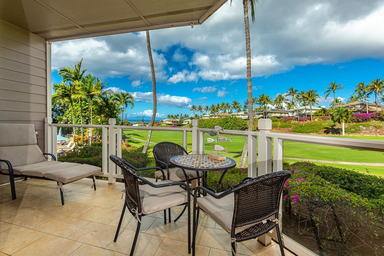 a view of a chairs and table in patio with a lake view