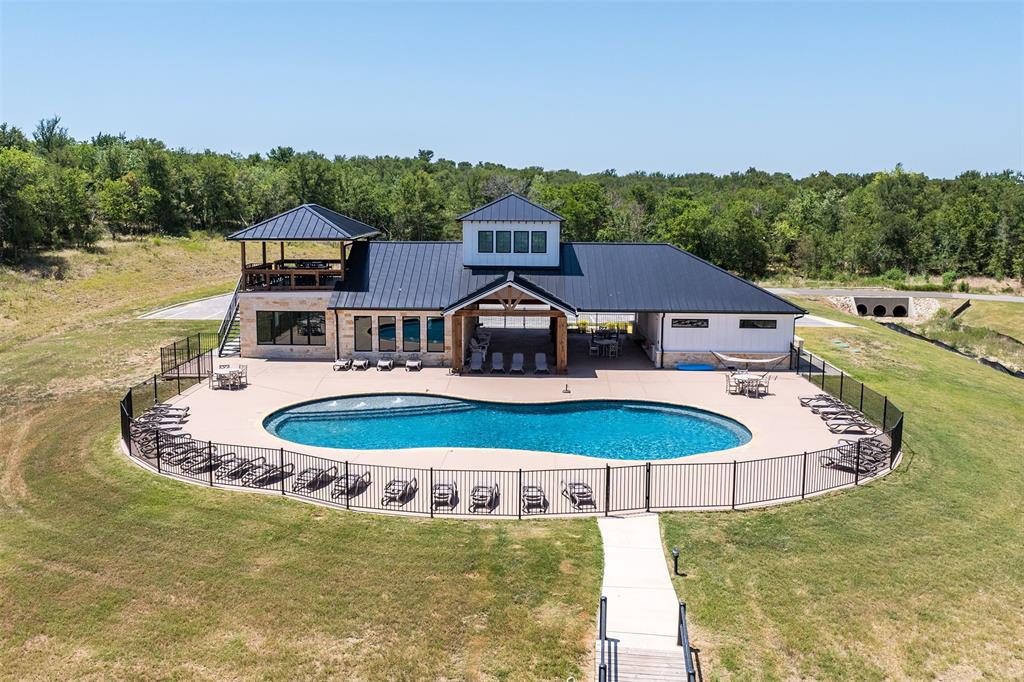 a view of a swimming pool with a yard