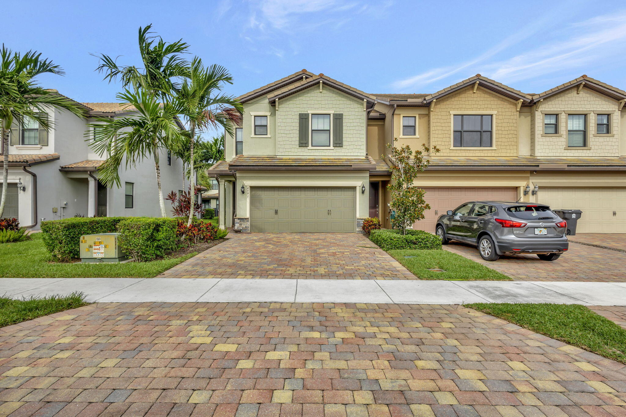 a front view of a house with a yard and garage