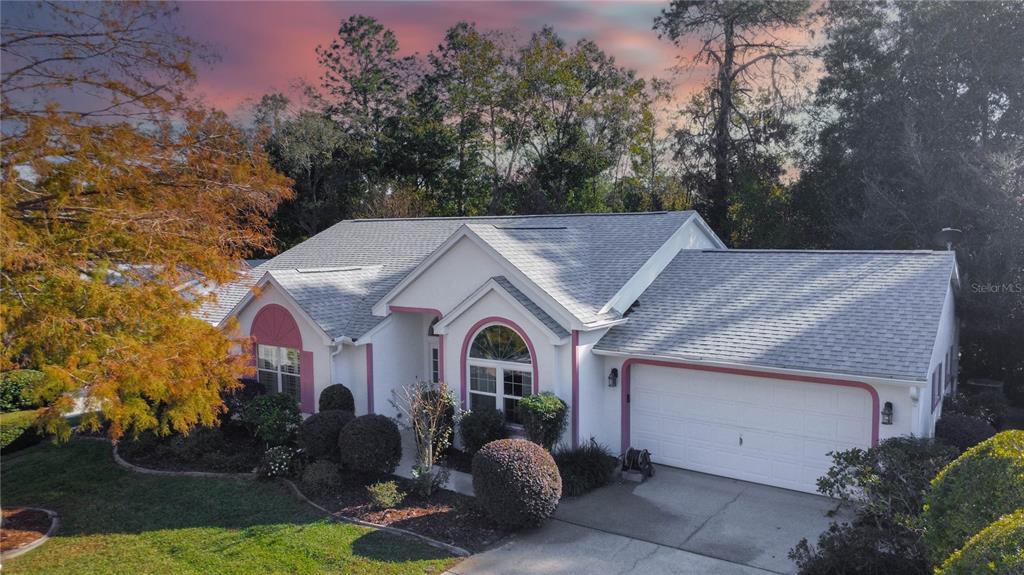 a aerial view of a house with yard and garage