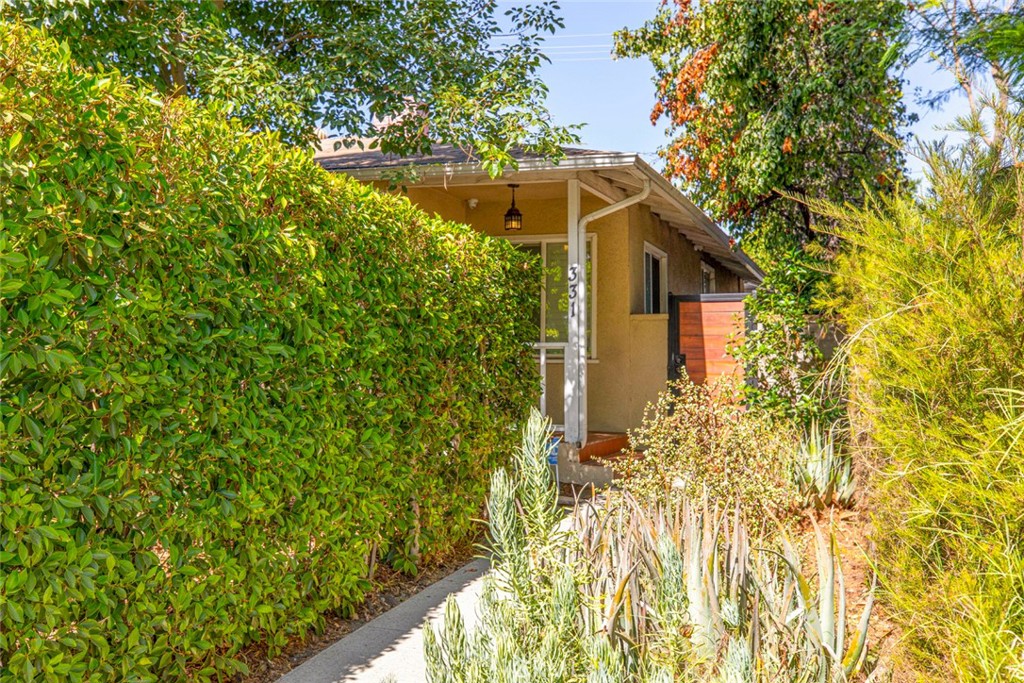 a yellow house with a yard in front of it