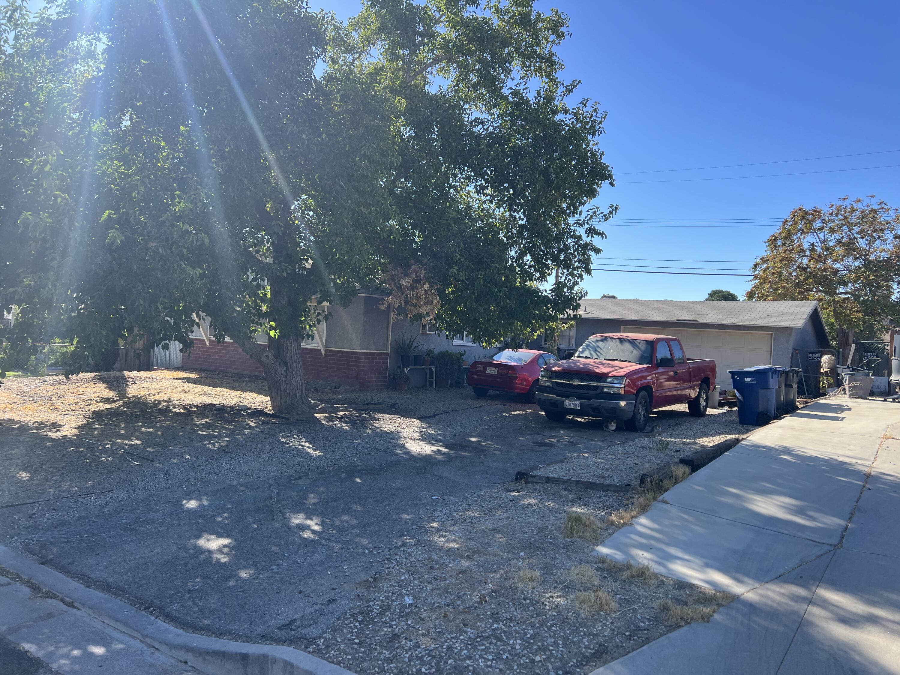 a view of a yard with cars