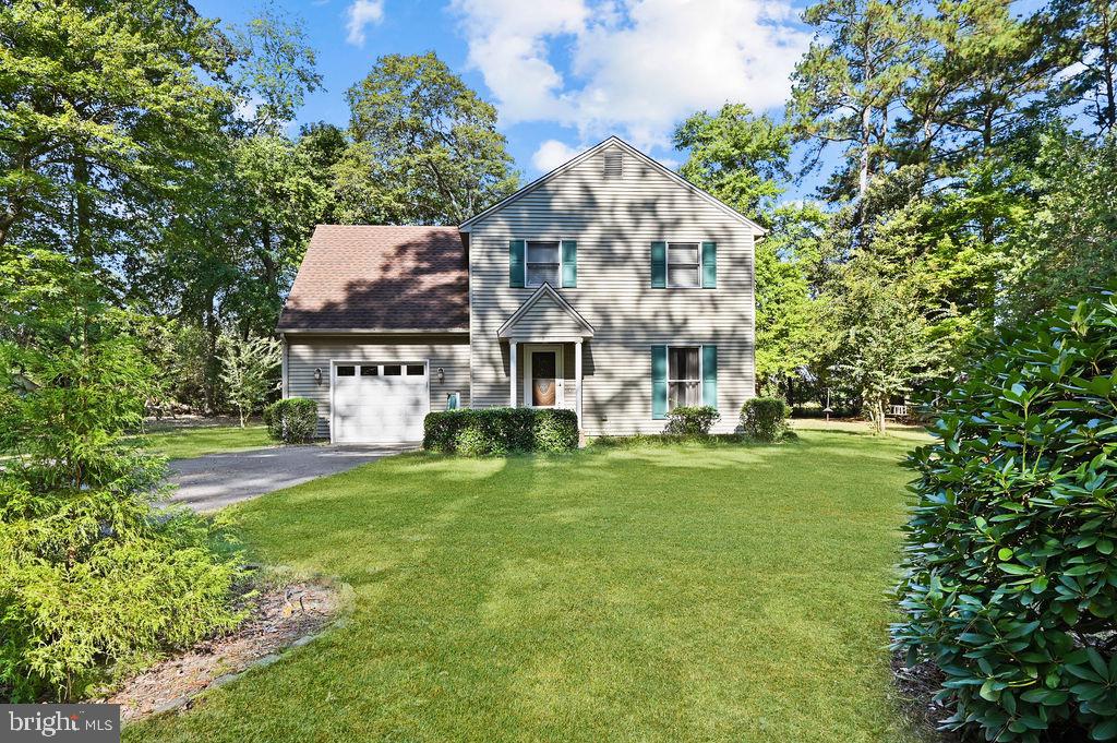 a aerial view of a house with a big yard plants and large trees