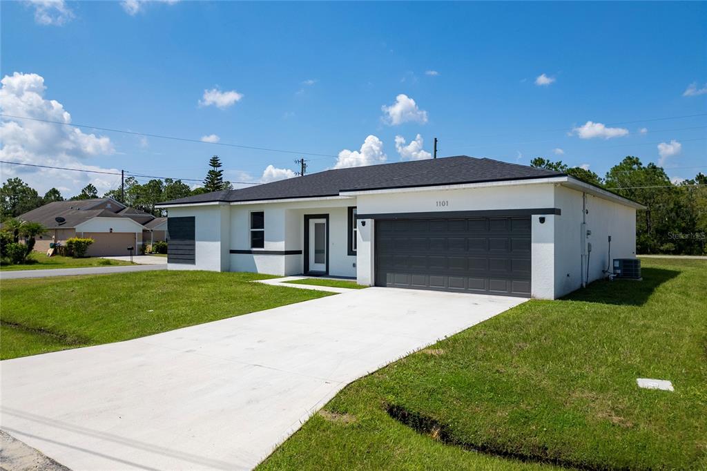 a front view of a house with a yard and garage