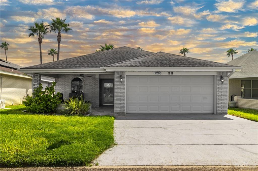 Ranch-style home with a yard and a garage