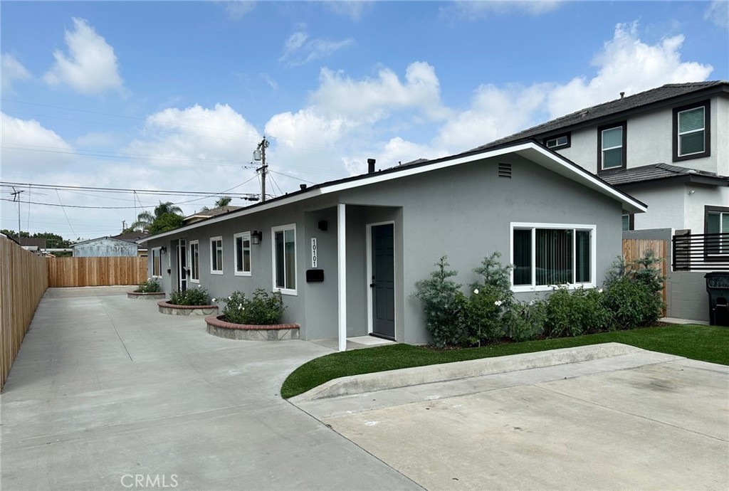 a front view of a house with yard and green space